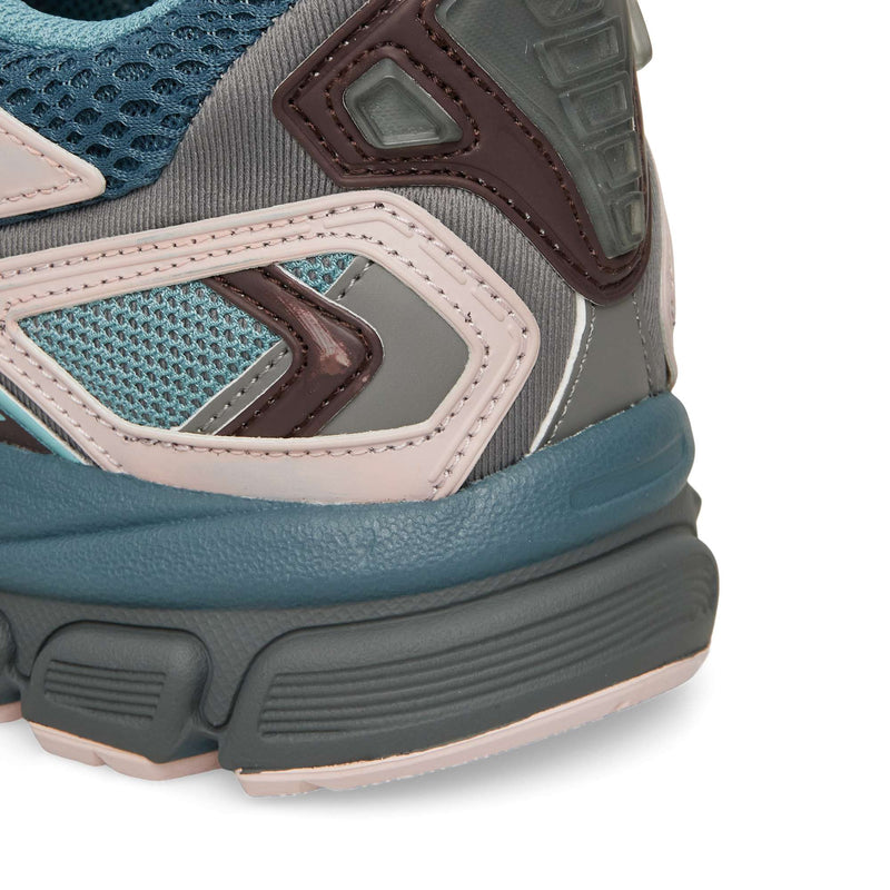 Close-up of the Reebok Premier Road Ultra heel area, featuring a multi-textured design in shades of blue, gray, and pale pink with a dual-density midsole.