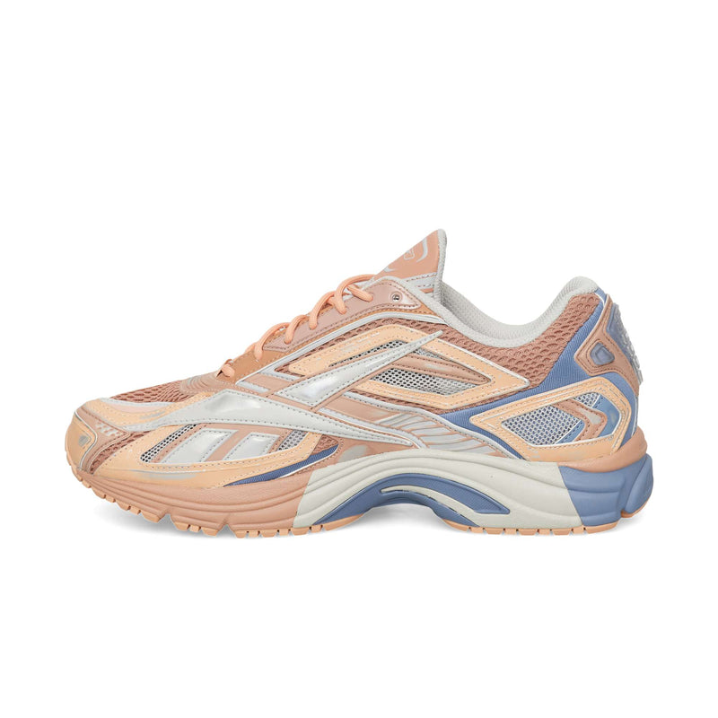 Side view of a peach and blue Reebok Premier Road Ultra featuring layered mesh and synthetic overlays over a dual-density midsole.