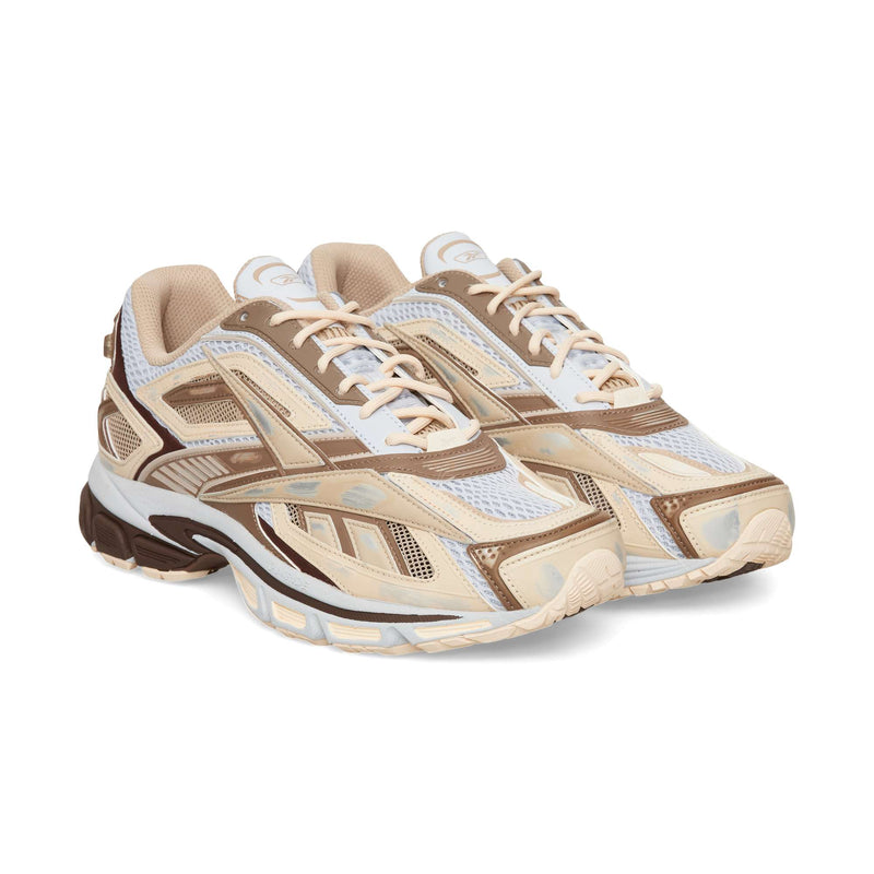 Reebok Premier Road Ultra running sneaker featuring a mesh base with tan and brown overlays, cream laces, and a thick, dark brown dual-density midsole.