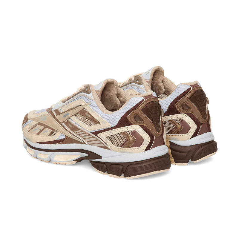 A pair of chunky Reebok Premier Road Ultra running sneakers in shades of brown, tan, and white, shown from a rear three-quarter angle.