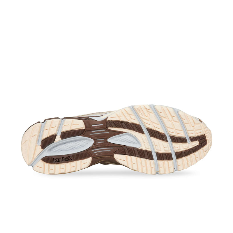 The light-colored rubber outsole of a Reebok Premier Road Ultra running sneaker with brown tread detailing.