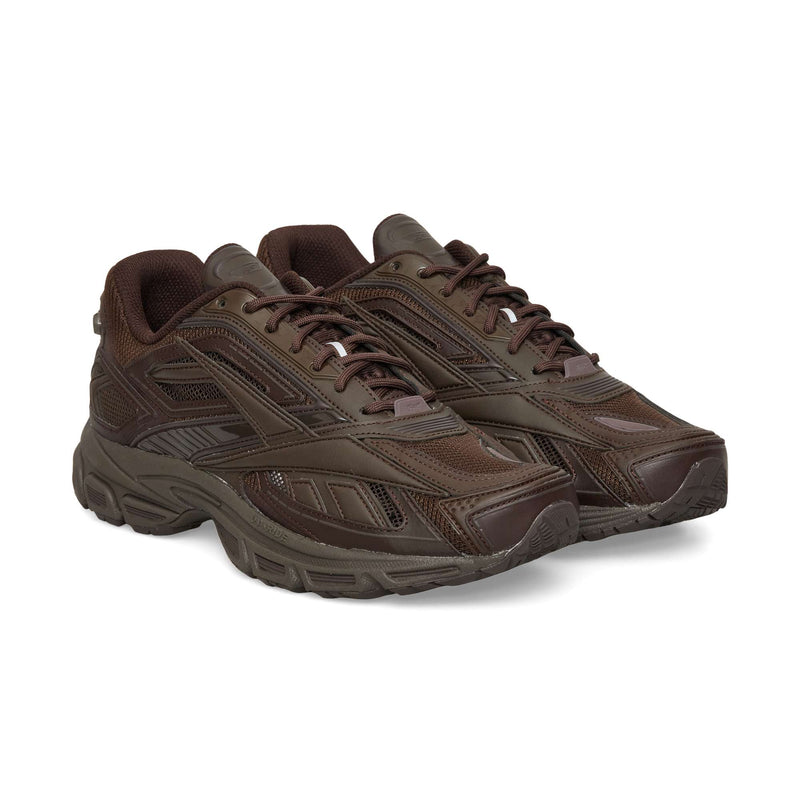 Pair of dark brown Reebok Premier Road Ultra low-top athletic sneakers with mesh panels, matching laces, and a dual-density midsole.