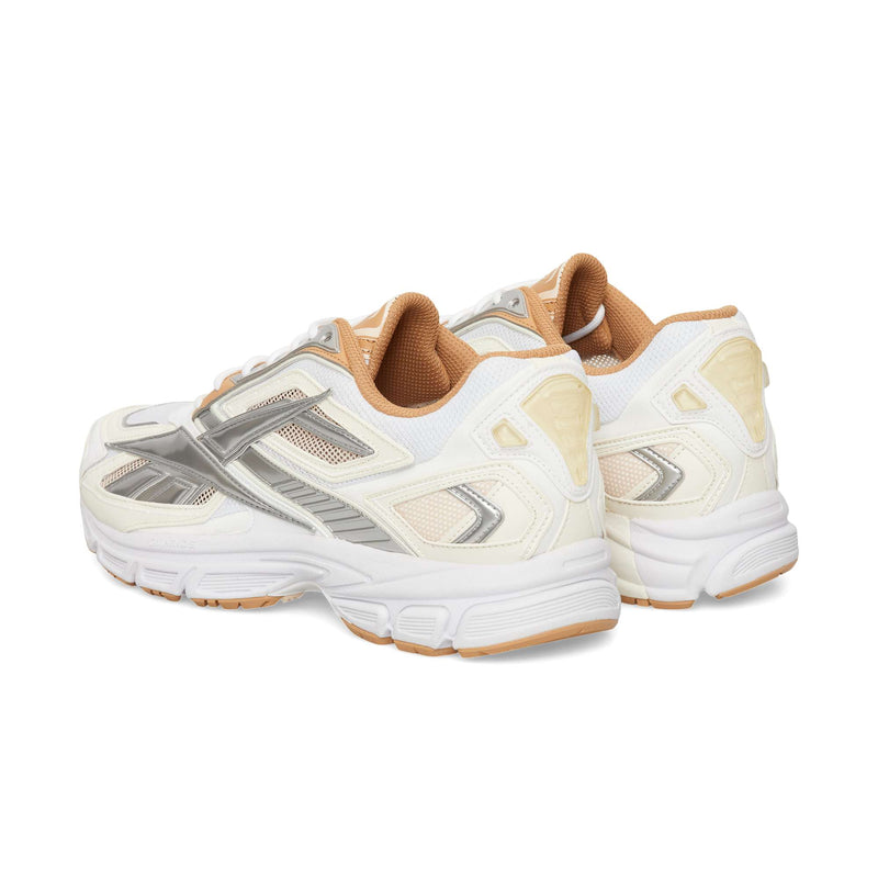 Rear three-quarter view of Reebok Premier Road Ultra sneakers in white, off-white, and metallic silver, featuring tan interior lining and outsoles.