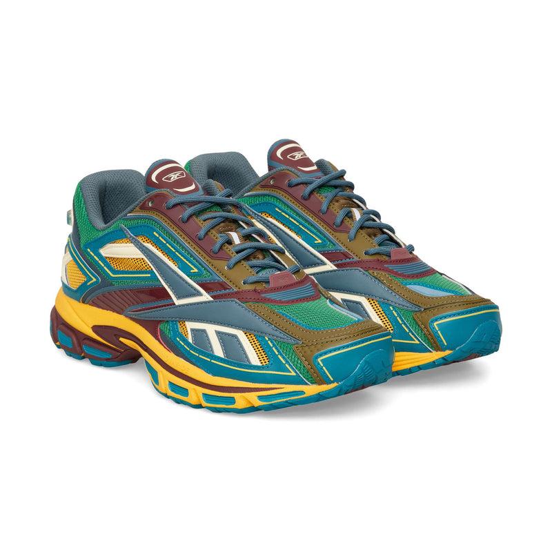 Low-top Reebok Premier Road Ultra running sneaker in a multicolor palette of teal, olive, maroon, and yellow with mesh and synthetic overlays.