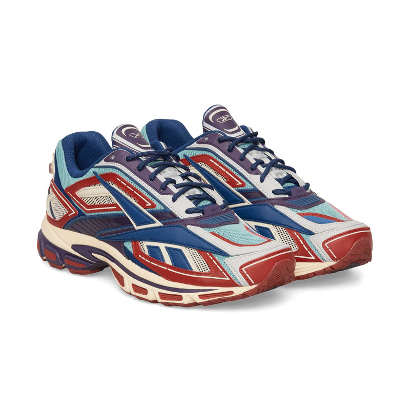 Low-top Reebok Premier Road Ultra running sneaker in a layered red, blue, and light blue design with a chunky cream and burgundy dual-density midsole.