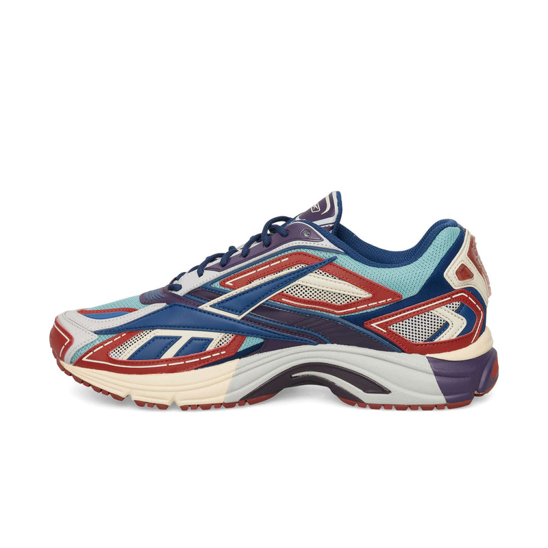 Reebok Premier Road Ultra low-top athletic sneaker in a multi-colored blue, red, cream, and white design featuring a layered mesh and synthetic upper with a dual-density midsole.