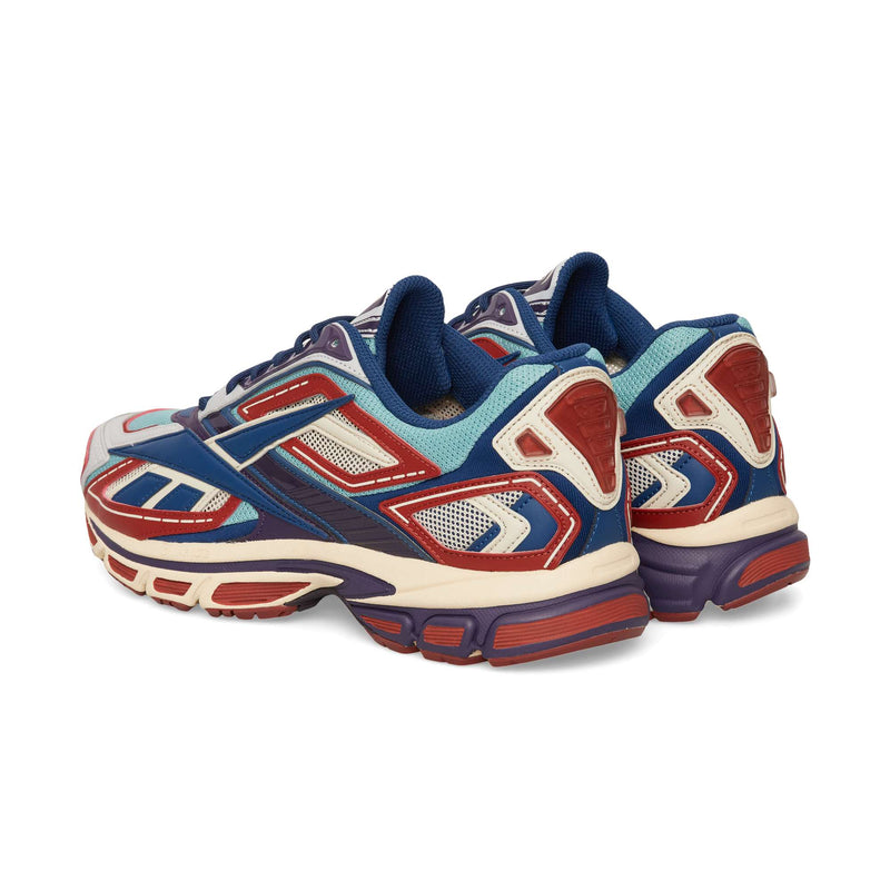 Two Reebok Premier Road Ultra running sneakers featuring blue, red, and cream paneling on a white background.