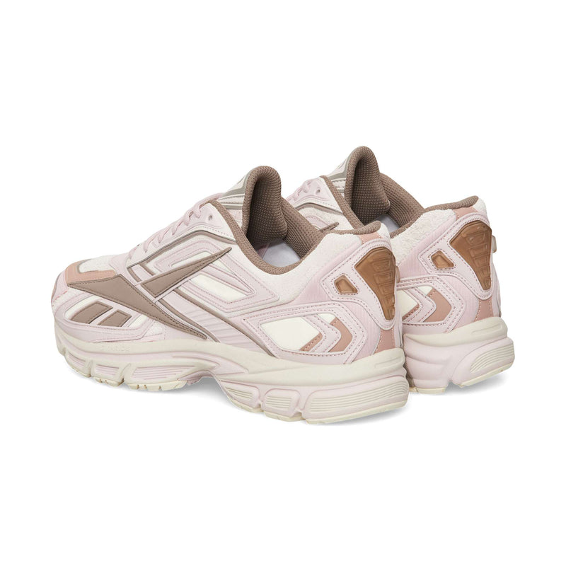 Side and back view of two light pink and cream Reebok Premier Road Ultra athletic sneakers featuring a dual-density midsole.