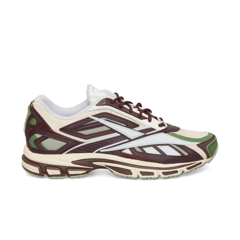 Low-top Reebok Premier Road Ultra sneaker in dark cocoa, vintage chalk, and tranquil blue with a multi-layered design, an archival running silhouette, and a chunky treaded sole.