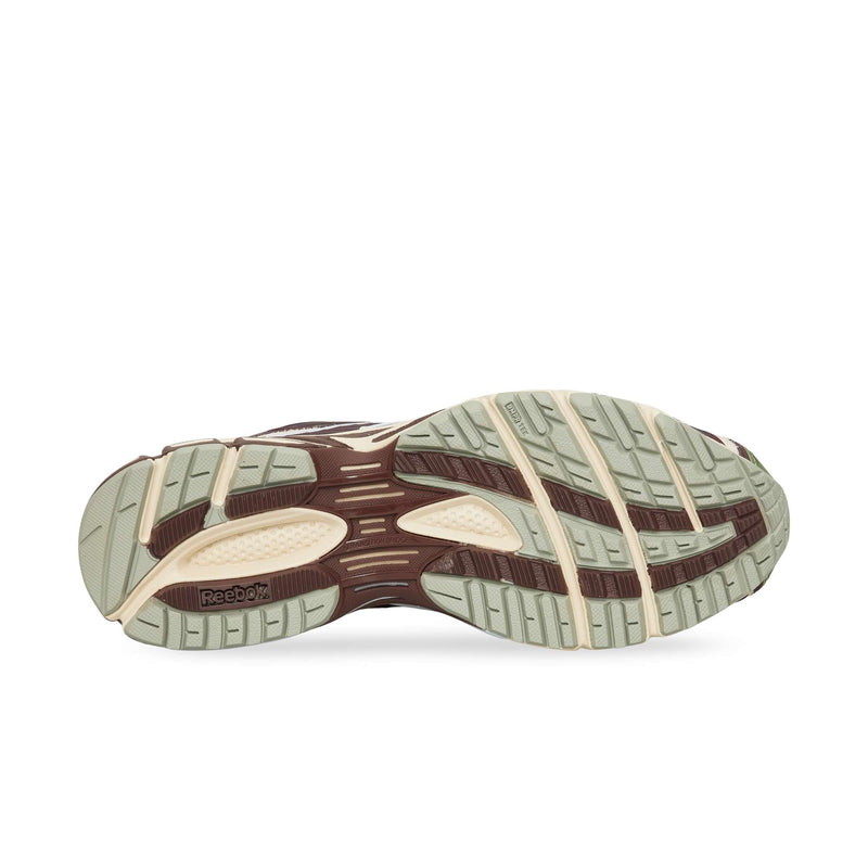 The treaded rubber outsole of a Reebok Premier Road Ultra running shoe featuring a multi-colored pattern of cream, brown, and light green sections.