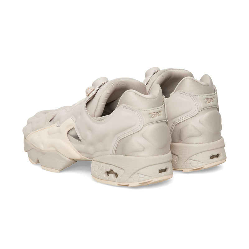 Beige Reebok Instapump Sliver slip-on athletic sneakers with a chunky, segmented sole and an inflatable pump mechanism on the tongue.