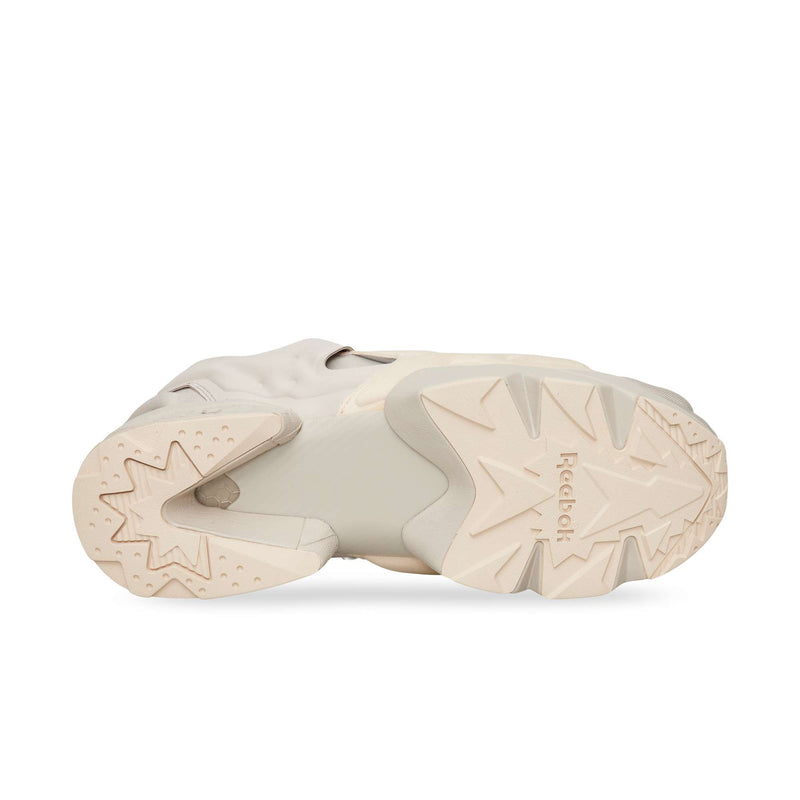 Beige Reebok Instapump Sliver slip-on sneaker shown from the sole, featuring a split-platform design with a textured, angular tread.