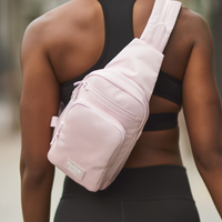 Person wearing a pink sling bag with a blurred background