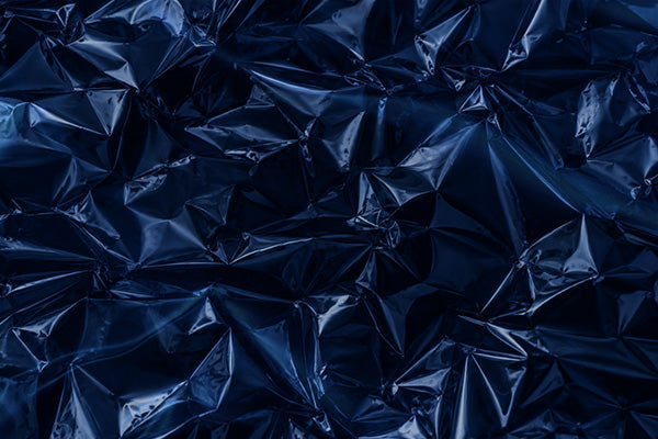 Dark navy blue crumpled textured material with a glossy, reflective surface.