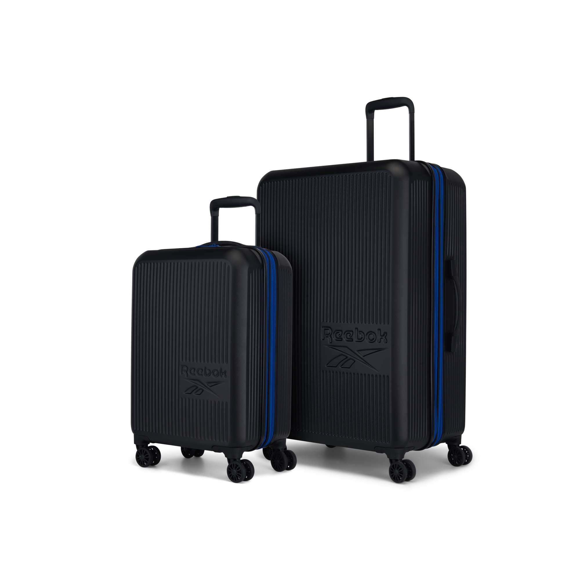 The Reebok Action Duo 2 Piece Luggage Set includes one small and one large black suitcase with vertical grooves, blue zippers, four spinner wheels each, and the Reebok logo on the front.