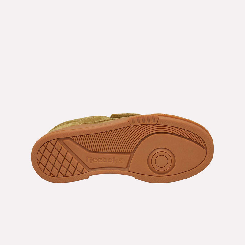 The image displays the brown rubber sole of a Reebok Club C LTD shoe, viewed from underneath. The sole is designed with textured patterns, a circular motif, and features the Reebok logo embossed near the center—emphasizing its timeless lifestyle classic style.