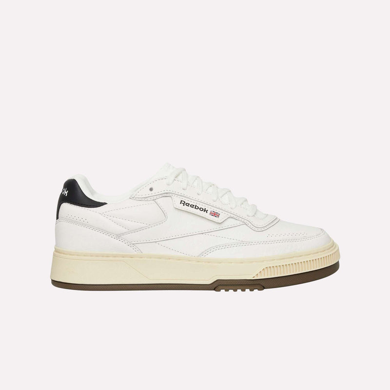 The Reebok Club C LTD Shoes are shown in a side profile view against a plain white background, featuring a white upper, cream-colored sole, black heel detail, and the classic Reebok logo on the side—an essential lifestyle staple.