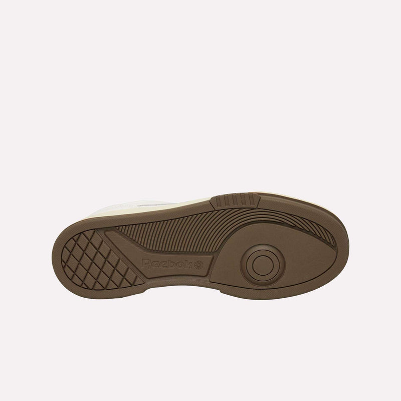 The brown rubber sole of the Reebok Club C LTD Shoes is displayed against a white background, highlighting its textured grip patterns and the iconic Reebok logo—a true lifestyle classic.