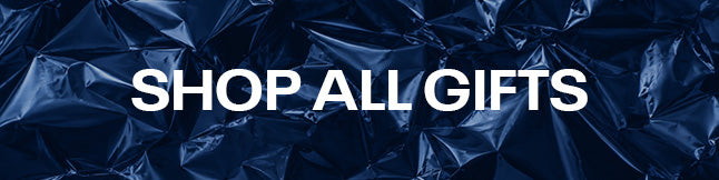 A dark blue crumpled foil background with large white text reading “shop all gifts” across the center.