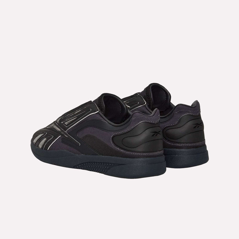 A pair of Reebok Hammer Pro LTD Shoes in black with dark purple accents, displayed from the back and side, feature a durable rubber sole and are set against a light gray background.