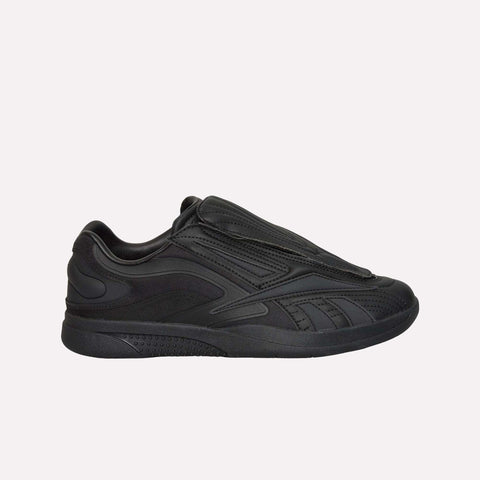 A pair of Reebok Hammer Pro LTD Shoes in black with a streamlined, contemporary look, highlighted by a concealed lace panel, sturdy rubber outsole, and understated stitching accents, shown in a side profile on a simple light backdrop.