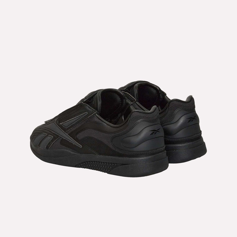 A pair of Reebok Hammer Pro LTD Shoes in black, featuring a chunky, durable rubber sole and a sleek, layered faux leather upper, displayed from the back and side angles against a plain white background.