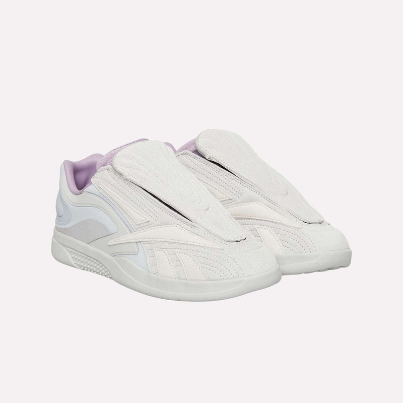 A pair of Reebok Hammer Pro LTD Shoes in white and light purple, showcasing a sleek, layered design without visible laces and equipped with a durable rubber sole for lasting comfort, displayed against a plain light background.