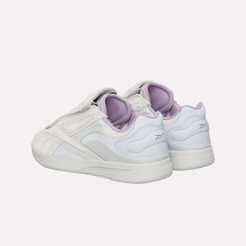 A pair of Reebok Hammer Pro LTD Shoes in white and light purple, featuring a futuristic design with a premium suede upper and a durable rubber sole, are displayed from the back and side against a plain light background.