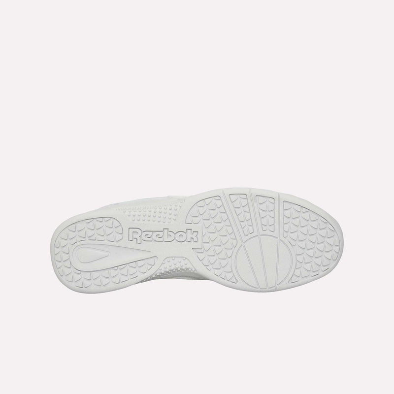 The image displays the white, durable rubber sole of the Reebok Hammer Pro LTD Shoes as seen from the bottom. The sole features textured patterns for enhanced grip and has “Reebok” embossed near the center.