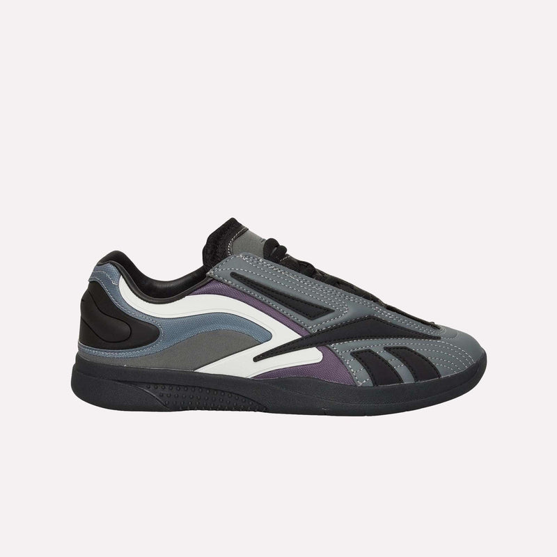 Presenting the Hammer Pro LTD Shoes by Reebok: these low-top sneakers showcase a contemporary mix of gray, black, purple, and white layered panels on a light base. Built with a faux leather upper for style and durability, and completed with a robust rubber sole, they offer an ideal balance of fashion-forward looks and functional comfort.