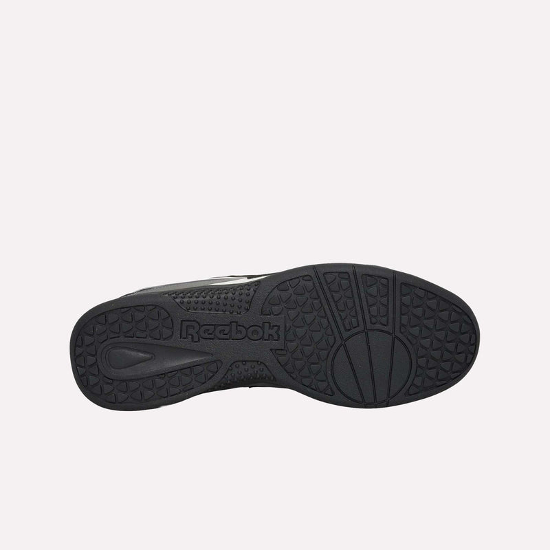 Bottom view of a black Reebok Hammer Pro LTD Shoe, displaying the textured, durable rubber sole with geometric patterns and the Reebok logo featured at the center. The shoe boasts a sleek faux leather upper for enhanced style and comfort.
