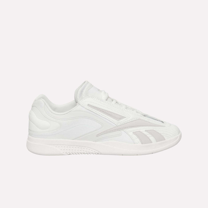 A pair of Reebok Hammer Pro LTD Shoes in white, featuring subtle light gray accents, a rounded toe, lace-up front, and a durable rubber sole is displayed against a plain white background. Crafted from faux leather, these sneakers seamlessly blend style and functionality for everyday wear.