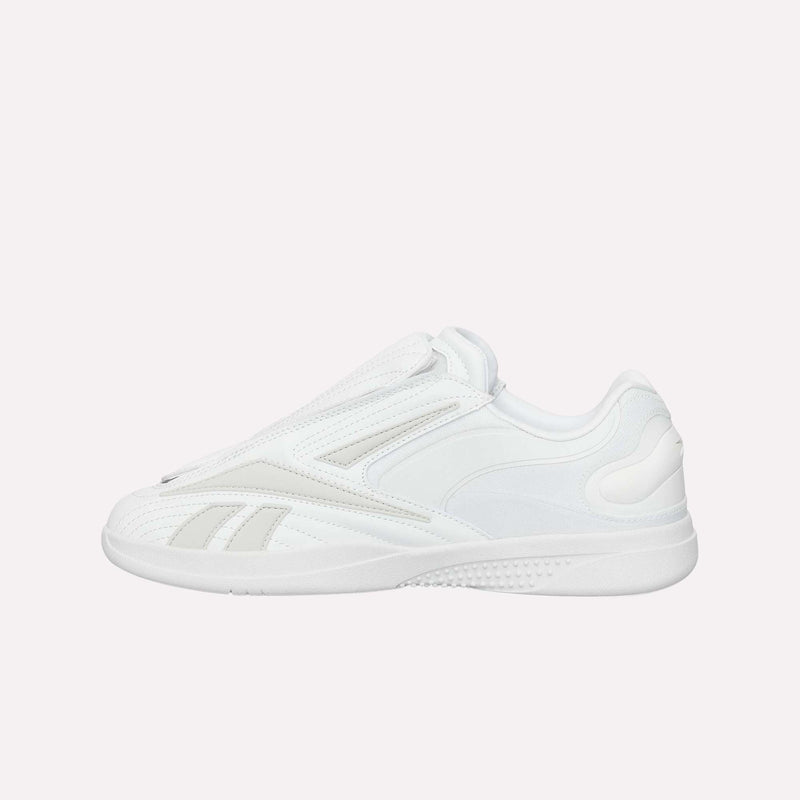 A white athletic sneaker crafted with smooth and textured panels, the Reebok Hammer Pro LTD Shoes showcase a sleek slip-on design with subtle Reebok logo accents on the side. Made from faux leather and set atop a durable rubber sole, these sneakers are presented against a plain white background.