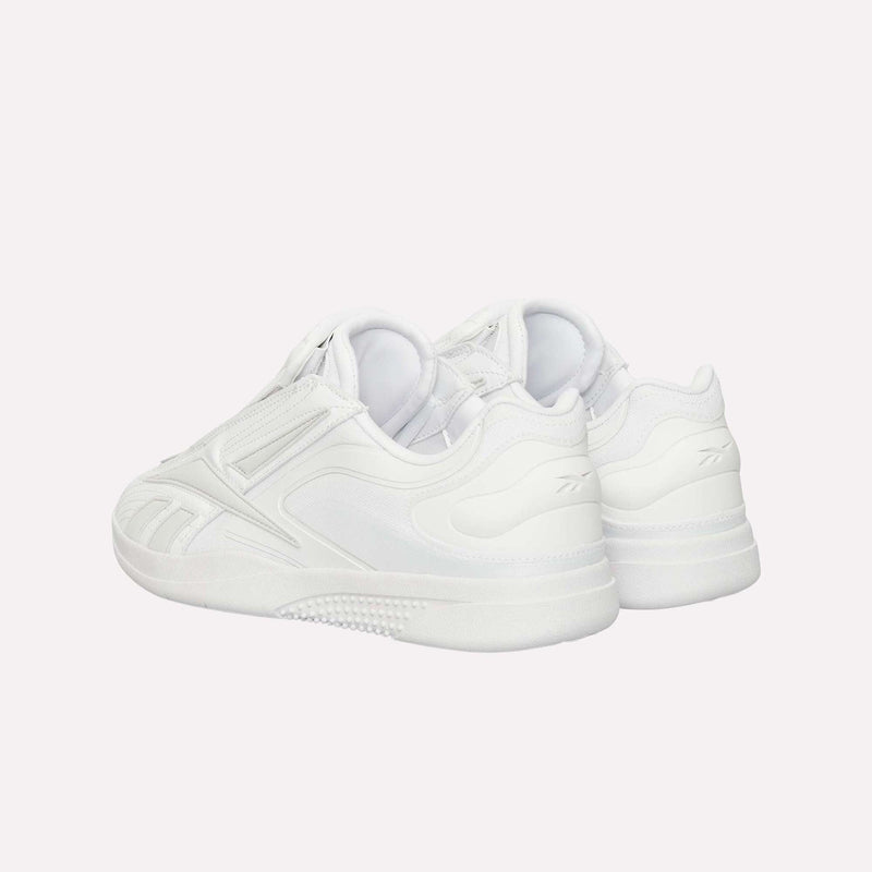 A pair of Reebok Hammer Pro LTD Shoes in white faux leather, showcasing a minimalistic design and durable rubber sole, displayed from the back and side against a plain white background.