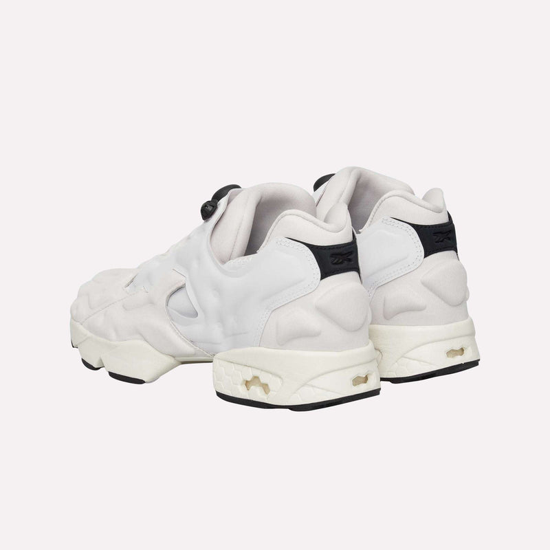 A pair of Instapump Sliver LTD Shoes by Reebok in white with chunky soles and black accents, showcasing signature InstaPump technology, displayed from the back and side against a plain light background.