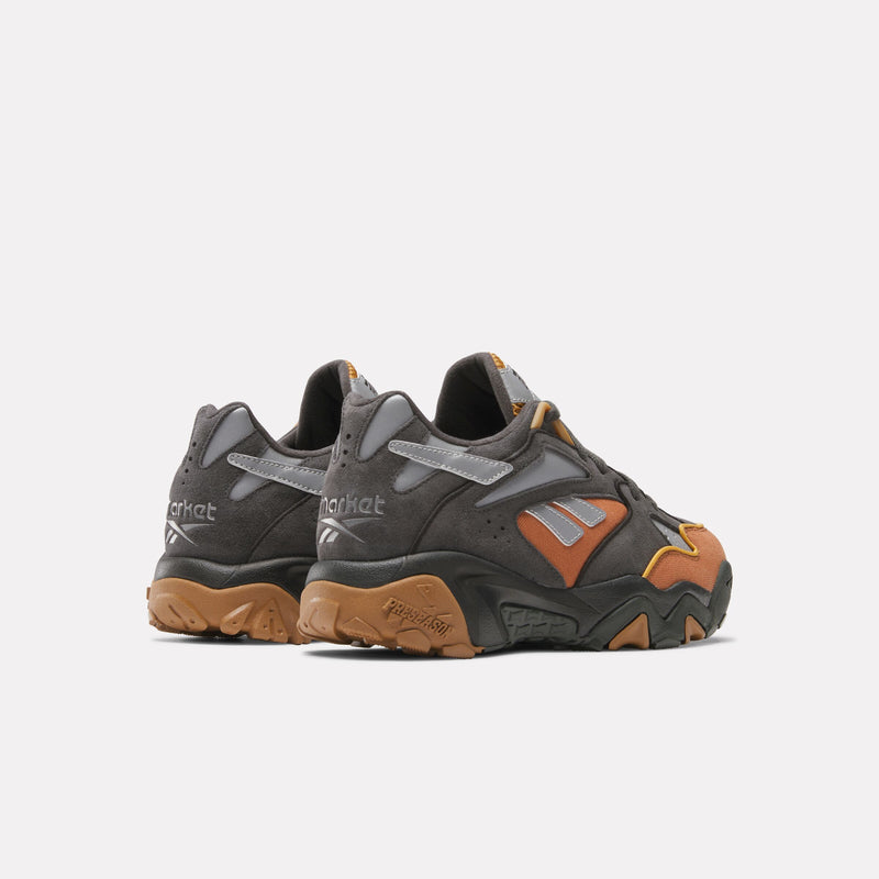 A pair of Reebok x Market Preseason 94 Low Shoes in gray, brown, and orange hues, showcased from a rear angled view with prominent Market branding and textured gum soles—ideal for elevating your training footwear rotation or highlighting the latest styles in the Preseason Collection.