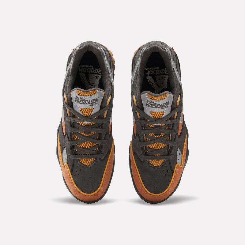 Top view of a pair of Reebok x Market Preseason 94 Low Shoes in grey, orange, and yellow with mesh fabric accents, laces, and “PRESEASON” text on the tongue against a white background.