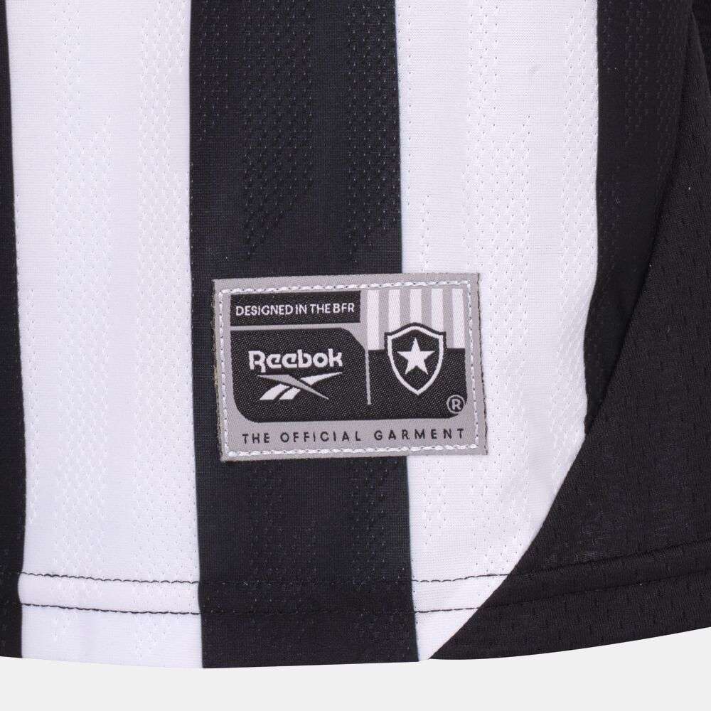 Close-up of a black and white striped Kids' Botafogo Youth Home Jersey by Reebok, featuring a rectangular patch with the star emblem and text: "DESIGNED IN THE BFR" and "THE OFFICIAL GARMENT.