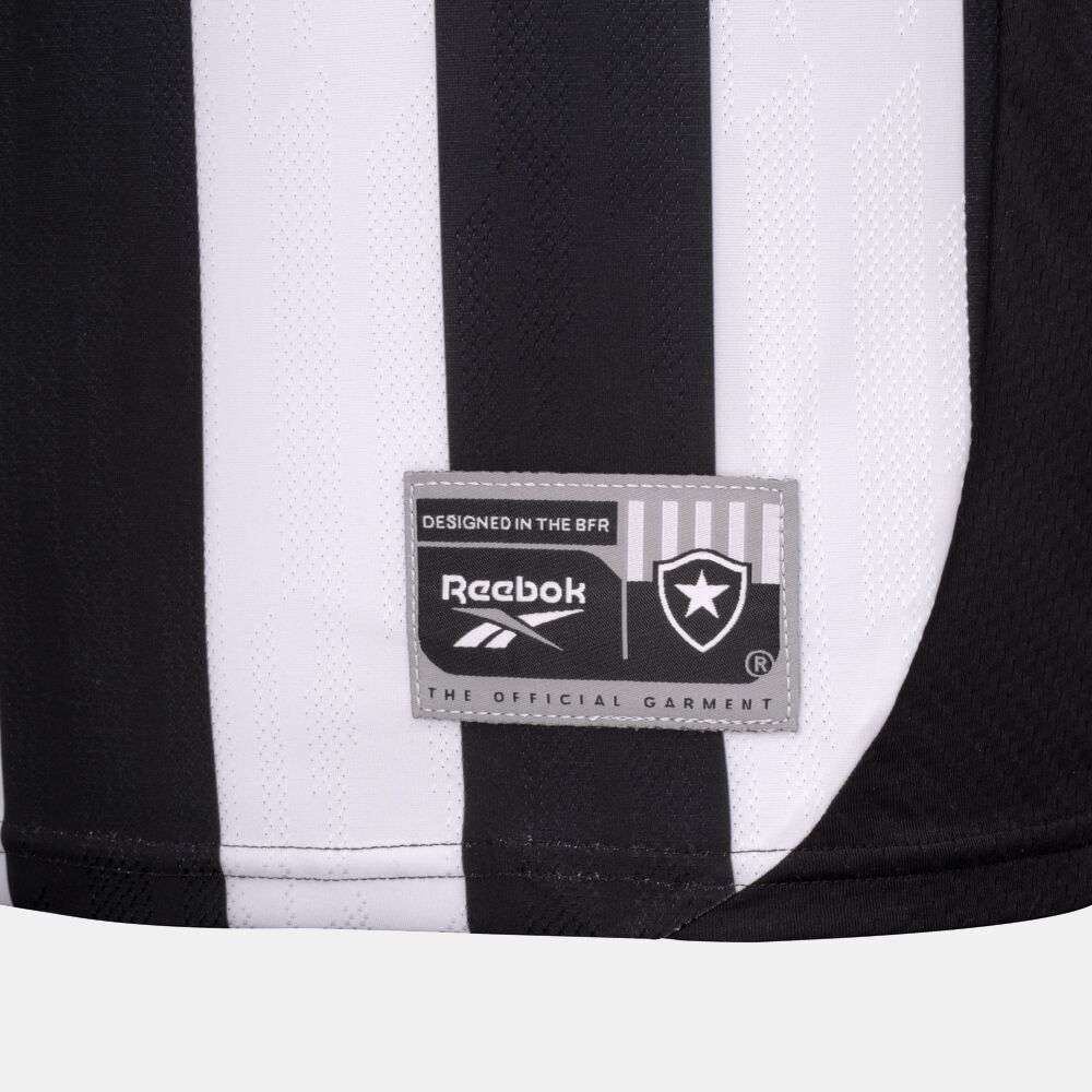 Close-up of the Botafogo Men's Home Jersey by Reebok: black and white stripes, gray patch with Reebok logo, shield emblem, and text reading "The Official Garment" and "Designed in the BFR.