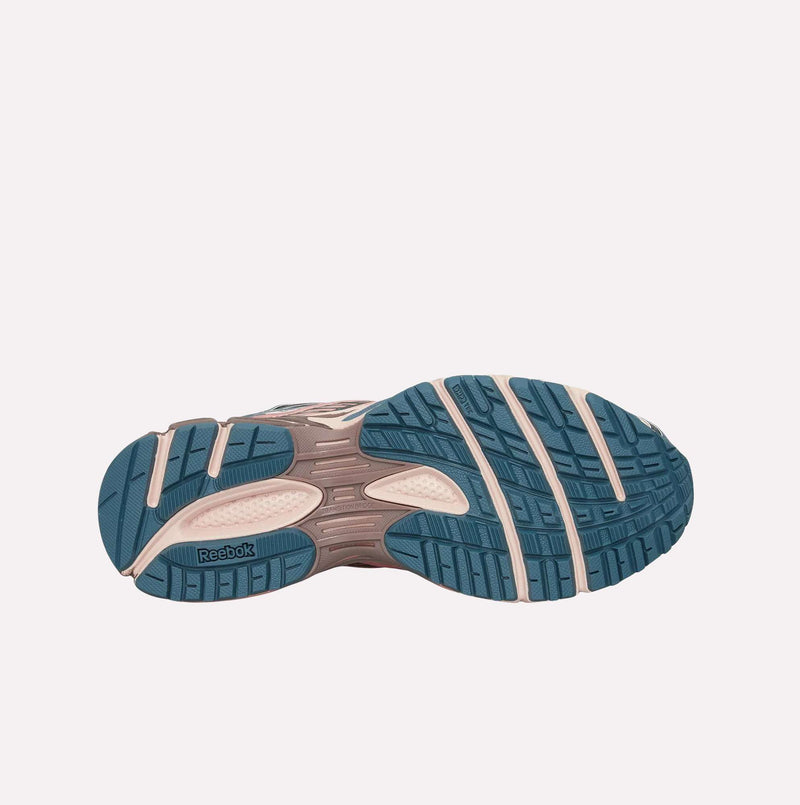 Shoe sole facing up, displaying the textured grip patterns and dual-density midsole detailing of the Reebok Premier Road Ultra LTD Shoes outsole in blue and beige, with the Reebok logo positioned near the heel.