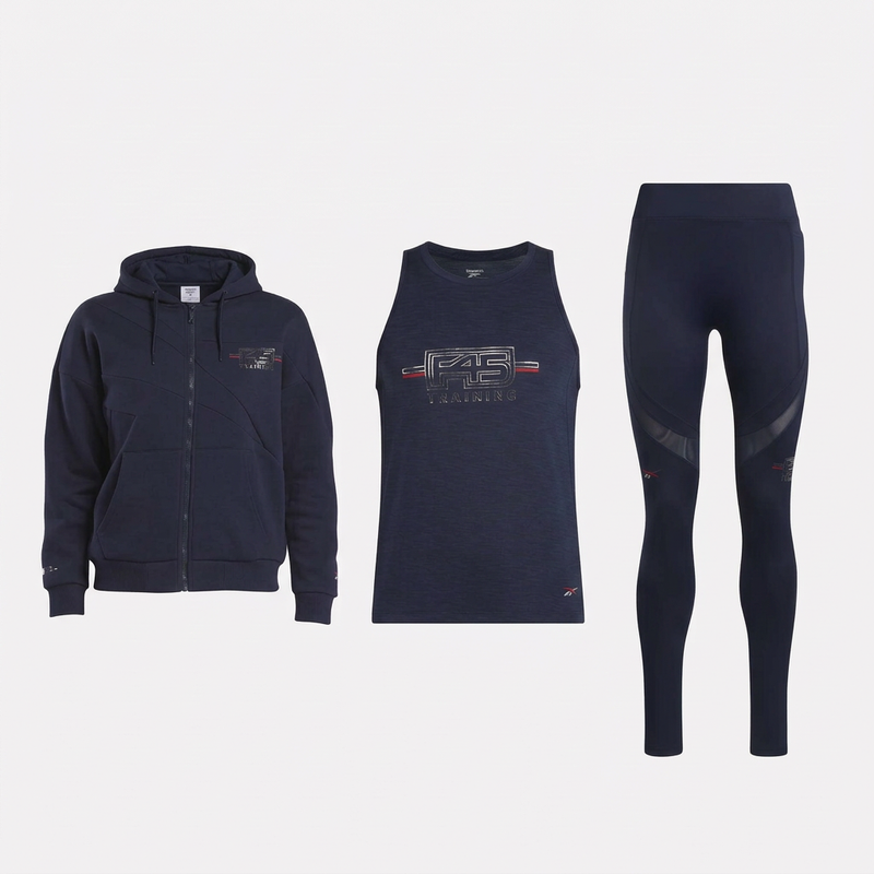 The Reebok Women's Core Layer Kit includes a matching navy zip-up hoodie, tank top, and full-length leggings with “F45 Training” logos—ideal for stylish workout layering.