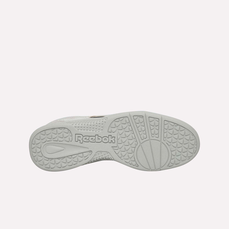 The sole of a white Reebok Pleasures Hammer Street Shoe is shown facing up, displaying textured patterns and the Reebok logo embossed in the center—an ideal detail for fans of grunge streetwear.