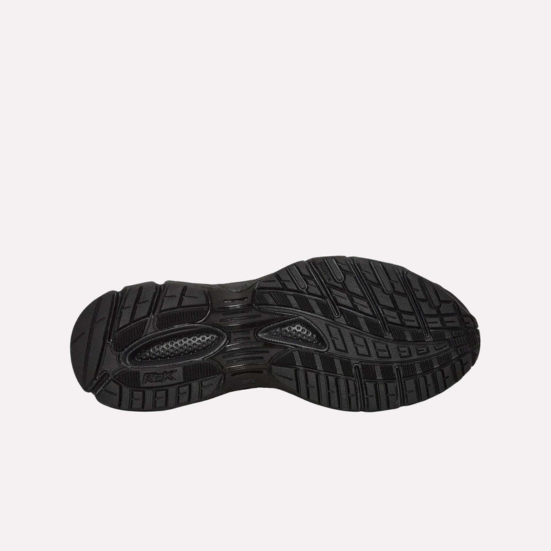 A black rubber sole with textured patterns and grooves for grip is shown against a plain white background—part of the Pleasures Premier Trinity KFS Shoes, a Reebok collaboration featuring a distinctive pony hair upper.