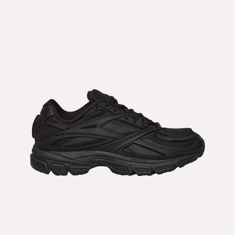 The Reebok Premier Road Modern LTD Shoes are athletic sneakers in black, shown in a side profile against a plain white background. Featuring mesh and synthetic overlays, a textured sole, and black laces, these shoes blend archival running shoe elements with contemporary design for a bold, futuristic statement.
