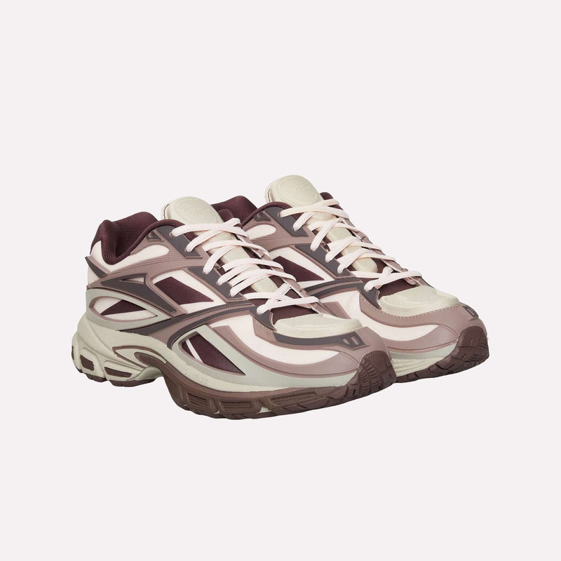 A pair of Reebok Premier Road Modern LTD Shoes in beige and burgundy, featuring chunky soles and inspired by archival running shoe designs, displayed on a plain light background.
