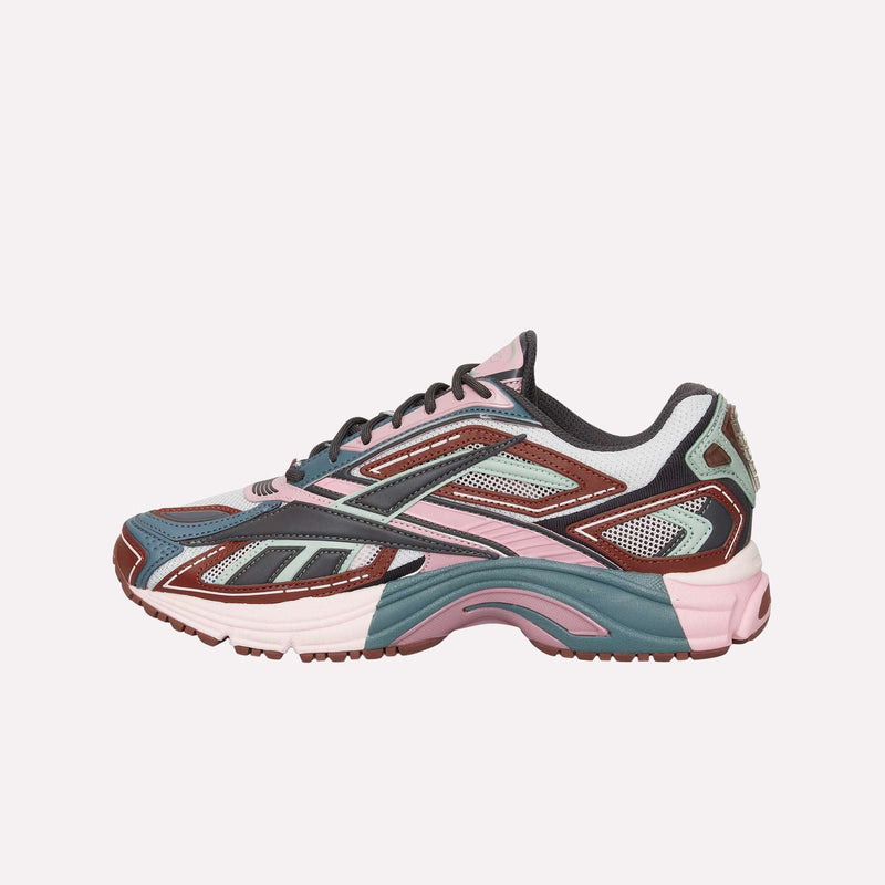 The Reebok Premier Road Ultra LTD Shoes are a stylish running sneaker crafted from mesh and synthetic materials in a vibrant mix of pink, teal, maroon, white, and black. Featuring a textured rubber sole and a dual-density midsole for enhanced comfort, this athletic shoe is presented against a plain white background.