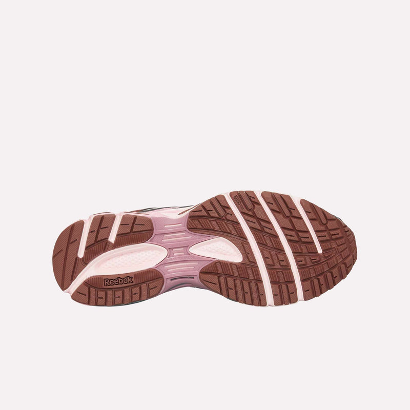 The image displays the bottom view of the Reebok Premier Road Ultra LTD Shoes, featuring a pink and brown rubber outsole with textured grip patterns designed for enhanced performance. The design likely includes a dual-density midsole to deliver increased comfort and support during activity.