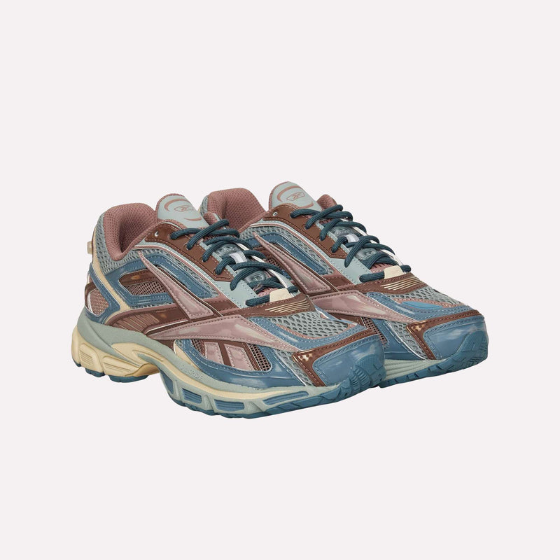 A pair of Reebok Premier Road Ultra LTD Shoes, inspired by archival running sneaker aesthetics and featuring multicolored blue, pink, brown, and beige tones with mesh and suede panels plus a dual-density midsole, displayed on a light background.