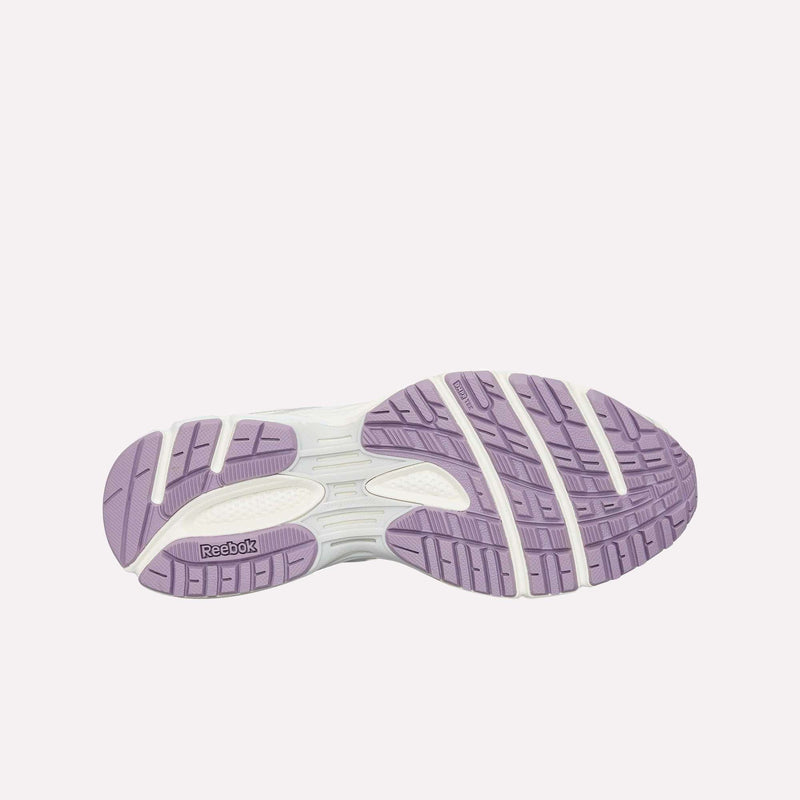 The image displays the outsole of the Reebok Premier Road Ultra LTD Shoes, showcasing a pattern of lavender and white rubber sections designed for traction and flexibility. Inspired by an archival running silhouette, the design also features the Reebok logo on one side of the sole.