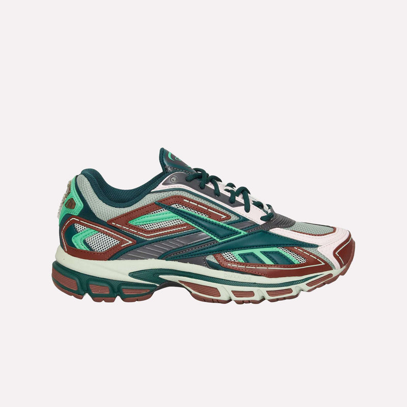 The Reebok Premier Road Ultra LTD Shoes are a stylish running silhouette inspired by the archival Premier Road Ultra, featuring mesh panels and green, brown, white, and teal accents. Designed for enhanced comfort with a dual-density midsole, these shoes are displayed in a side profile against a plain white background.